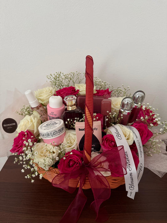 Gift basket with skincare products and flowers on a wooden surface