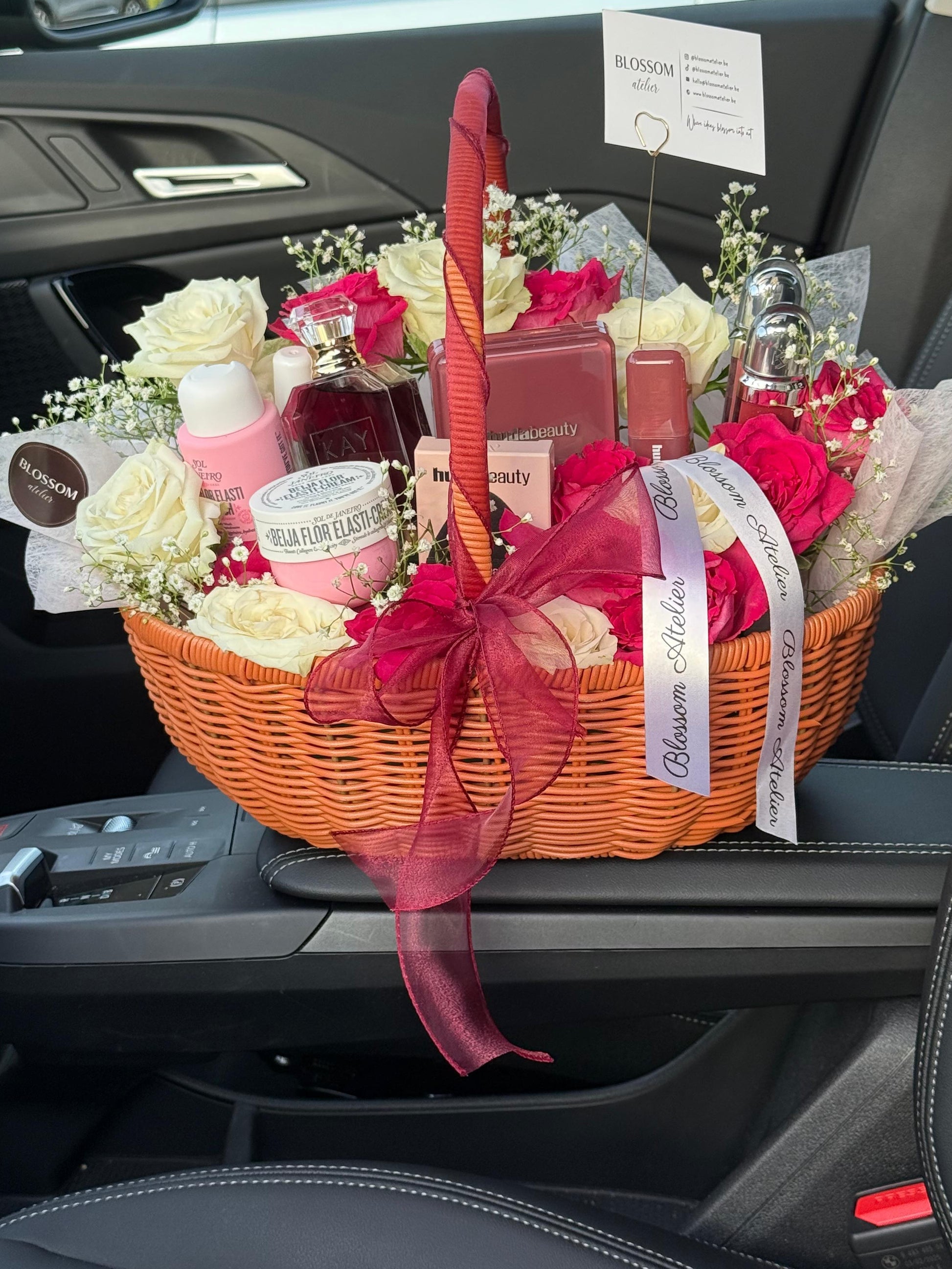 Gift basket with flowers and products on a car console